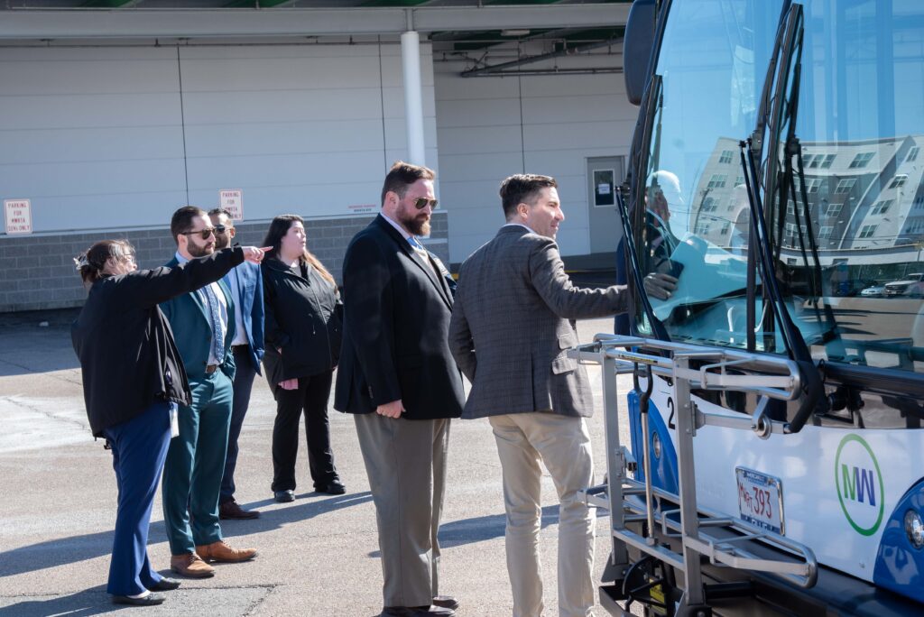 Administrator Jim Nee shows the bus to Rep. Jack Lewis